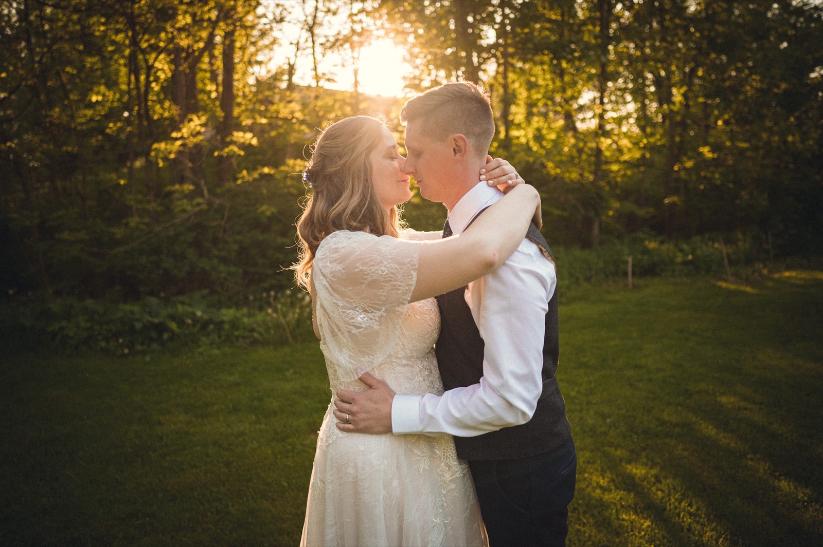 Bride and groom embracing at golden hour at a West Michigan wedding